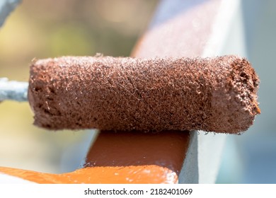 Paint Roller With Red Paint, Painting A Metal Fence With A Roller