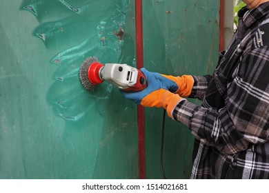 Paint And Rust Removing From Metal Plate, Worker Using Wire Brush At Grinder Power Tool