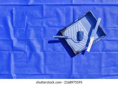 Paint Tray And Roller With Stir Stick On Blue Drop Cloth