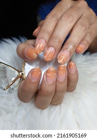 Paint your nails and orange   white gradients the tip  Make it look like salmon fillet white background 