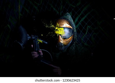 Paintball Mask zoomed in on.Splashes after direct hit to protecting mask in the paintball game.the photo as a paintball sphere is broken off at blow about a helmet.direct hit (paintball game)