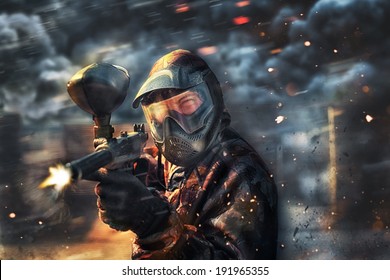 paintball sport player wearing protective mask shooting