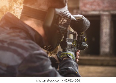 Paintball sport player wearing protective mask aiming gun - Shutterstock ID 417814666