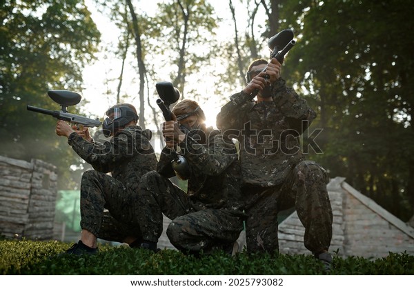 Paintball team,\
battle on playground in the\
forest