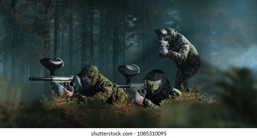 Paintball team shooting in forest battle