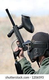 Paintball - Teen Paintballer With Gun, Wearing Protective Mask. Focus On Head.