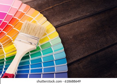 paintbrush on colorful paint swatches with copy space - Powered by Shutterstock