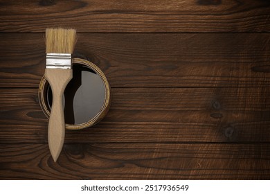 Paintbrush and Open Paint Can on Rustic Wooden Surface - Art, Craft, and DIY Concept - Powered by Shutterstock