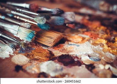 Paintbrushes closeup, artist palette and multicolor paint stains - Powered by Shutterstock