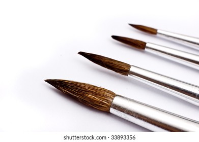 Paintbrushes in various sizes (shallow depth-of-field, selective focus on first brush)