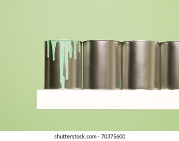 Paintcans In A Row On Green Background