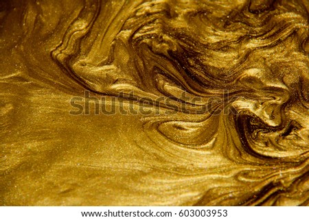 Painted background. Abstract emotional art. Modern design element. Golden liquid acrylic paints