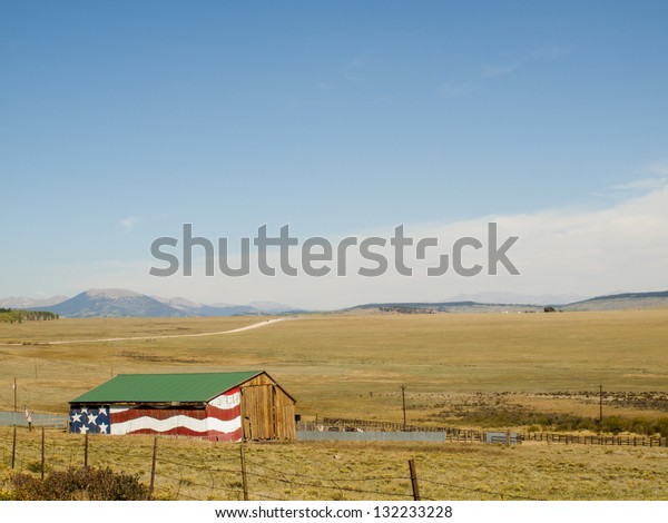 Painted big American Flag on exterior of old\
barn in Colorado.