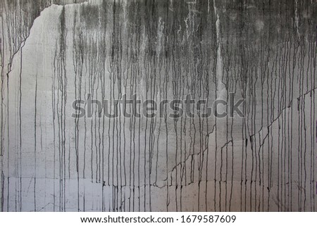 painted black dripping on gray wall, dripping liquid, paint flows, current paint, stains, current drops, the current paint on the concrete wall for the background, streams of fluid, vertical flows