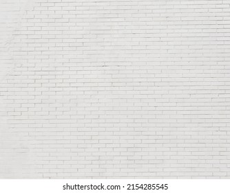 Painted Brick Wall And Weathered Sidewalk .