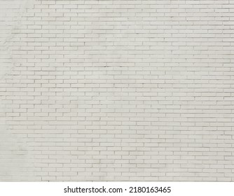 Painted Brick Wall And Weathered Sidewalk .