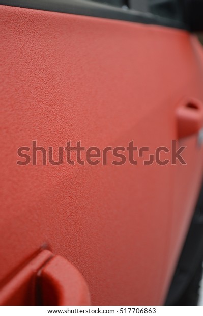 Painted car door of a\
polymeric paint