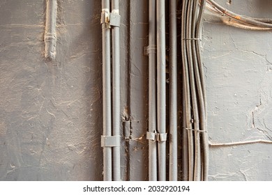 painted corrugated pipe for cable. On the wall Cable and wire in a metal sheath. - Shutterstock ID 2032920194