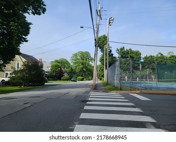 A painted crosswalk extending across a street.