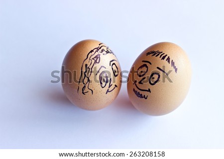 Painted easter eggs with man and woman smiling faces looking at each other . Conceptual image with happy couple. Isolated on white background