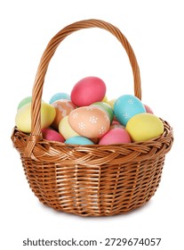Painted Easter eggs in wicker basket isolated on white