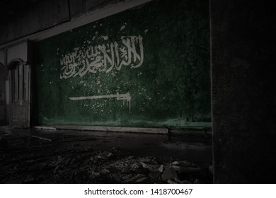 Painted Flag Of Saudi Arabia On The Dirty Old Wall In An Abandoned Ruined House. Concept