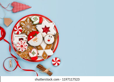 Painted gingerbread cookies and Christmas decoration isolated on blue background