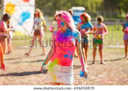 Painted girl dances at the Holi Festival