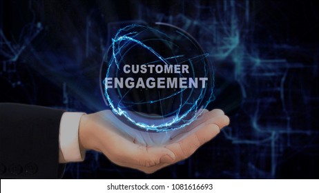 Painted hand shows concept hologram Customer engagement on his hand. Drawn man in business suit with future technology screen and modern cosmic background