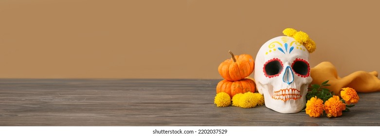 Painted human skull for Mexico's Day of the Dead (El Dia de Muertos, pumpkins and flowers on table. Banner for design - Shutterstock ID 2202037529