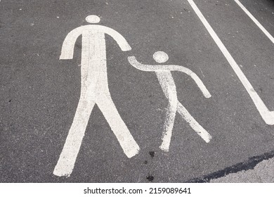 Painted icon of parent and child walking at car park
