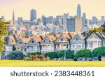 Painted Ladies Victorian houses in Alamo Square and a view of the San Francisco skyline and skyscrapers. Photo processed, in pastel colors