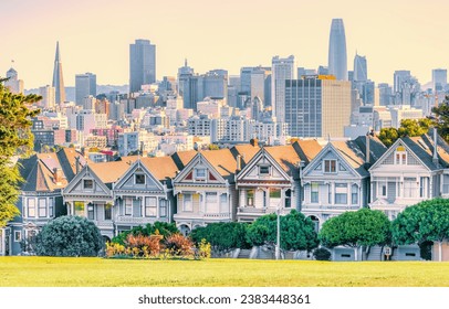 Painted Ladies Victorian houses in Alamo Square and a view of the San Francisco skyline and skyscrapers. Photo processed, in pastel colors