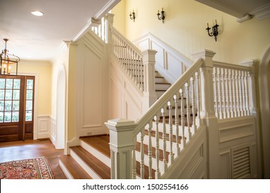 Painted And Natural Stained Wood Stairs. Classic And Tradition Design With Ornate Banister