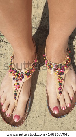 Painted pink toenails, sandals, outside,