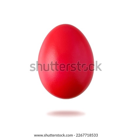 Painted in red natural easter chicken egg flying isolated on white background. One red festive egg closeup. Happy Easter spring decoration.