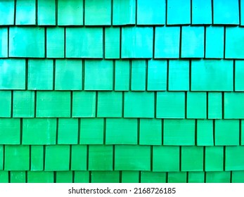 a painted retro green house cabin wooden shingles wood shingle covering weather protection wall