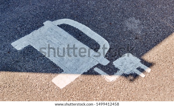 Painted Road Sign Indicating Electric Vehicle\
Recharging Parking\
Point