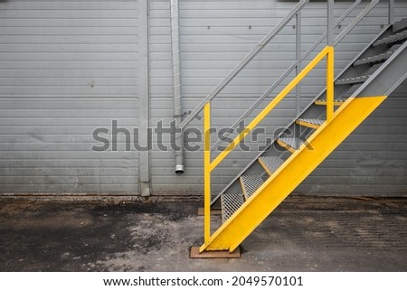 Similar – Image, Stock Photo Industrial warehouse staircase with a glimpse of neon light