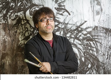 Painter Artist With Black Glasses Posing In Front Of His Mural Paint