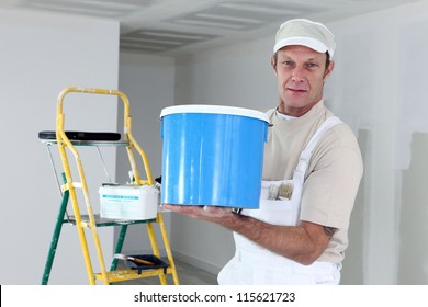 Painter Holding A Can Of Paint