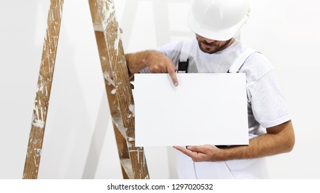 painter man with ladder showing blank white placard, copy space template - Powered by Shutterstock