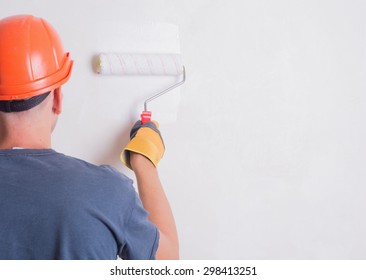 Painter On Stepladder Painting Wall With Brush