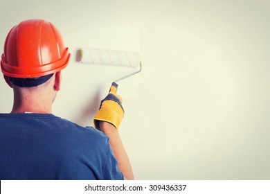 Painter On Stepladder Painting Wall With Brush