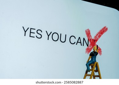 Painter on stepladder redrawing on white board letter t word can't creating new sentence yes you can, personal growth concept