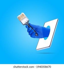 Painter Online Service Concept. Worker Showing Paint Brush Out From Phone Screen Isolated On Blue Background. Online Renovate Support Conceptual.