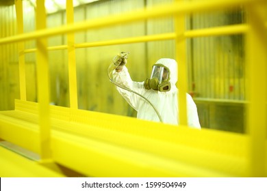 The Painter Paints The Iron Element In Yellow. Industrial Painting Parts. Metal Designs With Airbrush