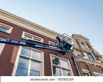 Painter In Platform Maintaining Old Building. Deventer, Overijssel, Netherlands.