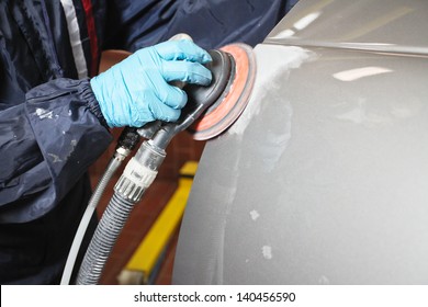 Painter Polishes A Car Body Component