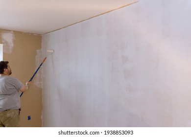 The Painter Primed The Wall With A Primer Repair The Wall After Applying Gypsum Plaster On Using Paint Roller Brush